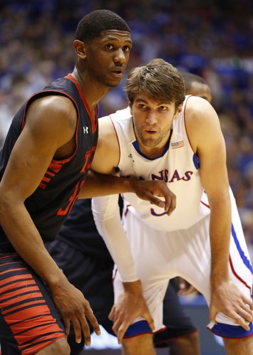 Kansas center Jeff Withey waits for an inbound pass as he is covered by Texas Tech forward Jordan Tolbert during the first half, Monday, March 4, 2013 at Allen Fieldhouse.