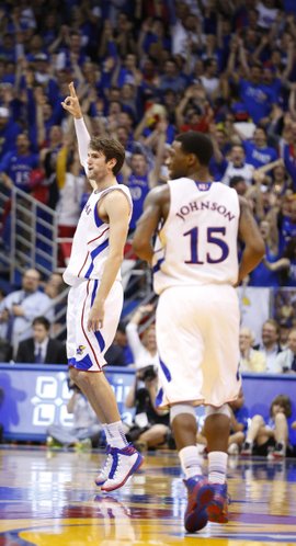Kansas center Jeff Withey signals "three" after hitting one against Texas Tech during the first half, Monday, March 4, 2013 at Allen Fieldhouse.