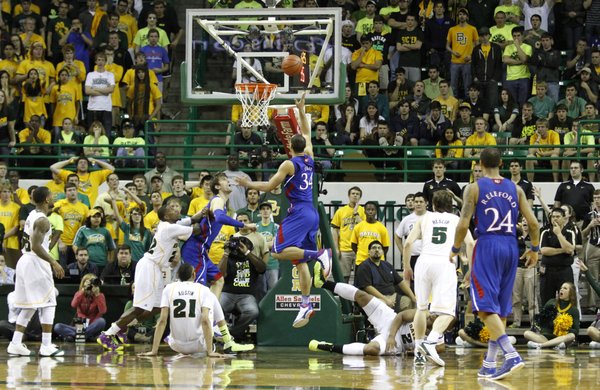 Perry Ellis (34) splits defenders for a layup in KU's 81-58 loss to the Baylor Bears Saturday in Waco.