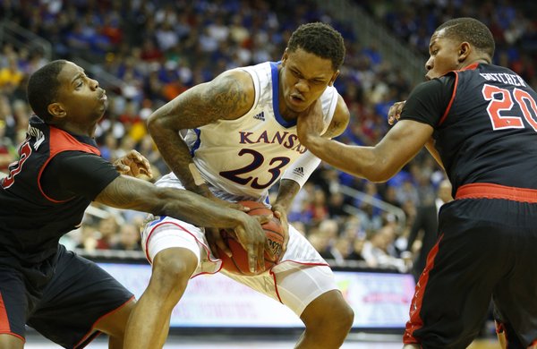 Kansas guard Ben McLemore looks to maintain possession against Texas Tech players Daylen Robinson, left, and Toddrick Gotcher during the second half of the second round of the Big 12 tournament on Thursday, March 14, 2013 at the Sprint Center in Kansas City, Missouri.