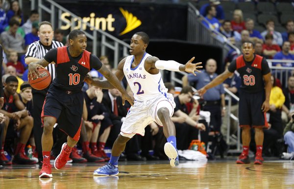 Kansas guard Rio Adams defends against Texas Tech guard Daylen Robinson during the second half of the second round of the Big 12 tournament on Thursday, March 14, 2013 at the Sprint Center in Kansas City, Missouri.