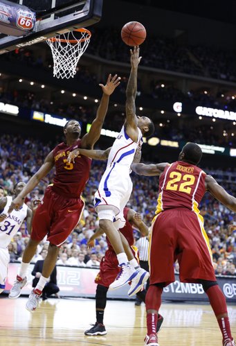 Kansas guard Naadir Tharpe heads to the bucket between Iowa State players Melvin Ejim (3) and Anthony Booker (22) during the second half of the semifinal round of the Big 12 tournament on Friday, March 15, 2013 at the Sprint Center in Kansas City, Missouri.