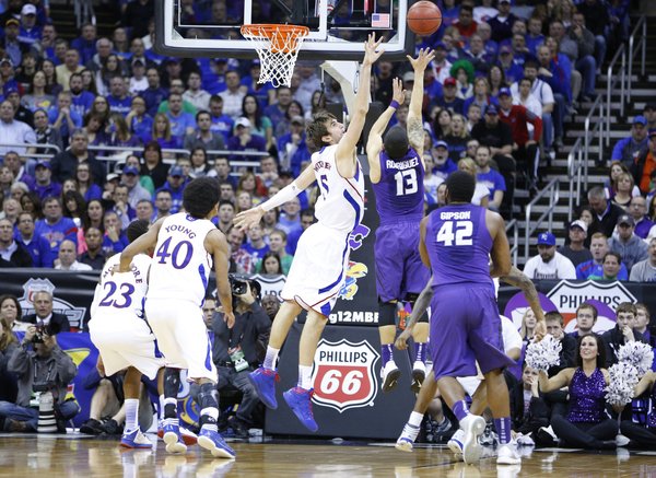 Kansas center Jeff Withey defends against a shot from Kansas State guard Angel Rodriguez during the second half of the Big 12 tournament championship on Saturday, March 16 2013 at the Sprint Center in Kansas City, Mo.