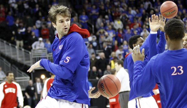 Jeff Withey tosses a behind his back pass during warm-ups with the Jayhawks before their second-round game against Western Kentucky Friday, March 22, 2013 at the Sprint Center in Kansas City, Mo.