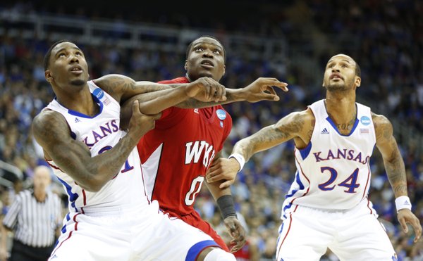 Kansas players Jamari Traylor, left, and Travis Releford work for position on a rebound with Western Kentucky forward Kene Anyigbo during the first half on Friday, March 22, 2013 at the Sprint Center in Kansas City, Mo.