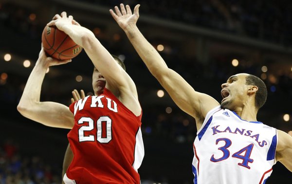Kansas forward Perry Ellis misses a rebound as it goes to Western Kentucky forward Aleksejs Rostov during the first half on Friday, March 22, 2013 at the Sprint Center in Kansas City, Mo.