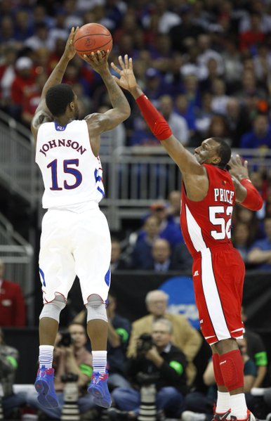 Kansas guard Elijah Johnson is defended on the shot by Western Kentucky guard T.J. Price during the first half on Friday, March 22, 2013 at the Sprint Center in Kansas City, Mo.