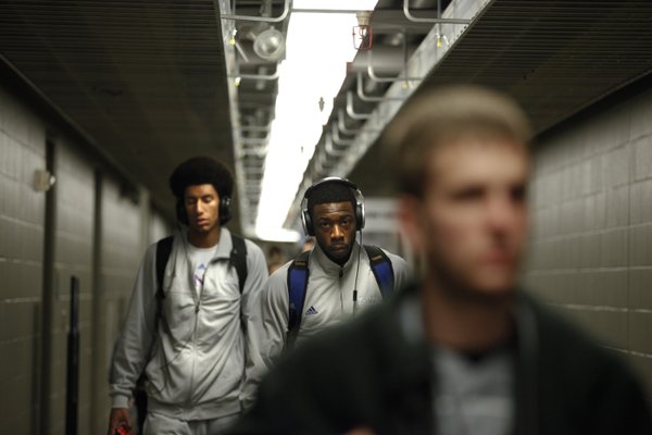 Kansas players Elijah Johnson, right, and Kevin Young make their way to the team locker room before practice, Saturday, March 23, 2013 at the Sprint Center in Kansas City, Mo.