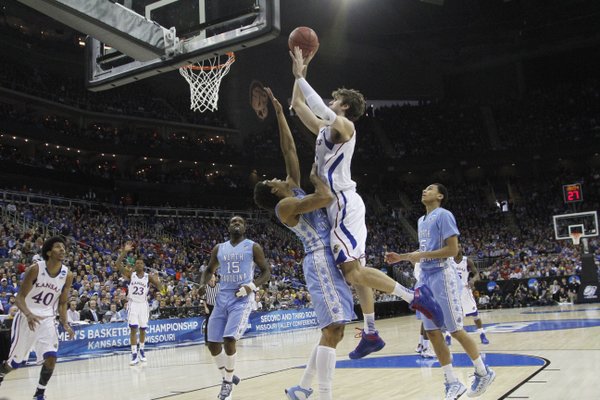 Kansas center Jeff Withey puts up a shot over North Carolina forward James Michael McAdoo in the first half on Sunday, March 24, 2013 at the Sprint Center in Kansas City, Mo..