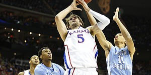 Kansas center Jeff Withey fights for a rebound with North Carolina players Brice Johnson, right, and Desmond Hubert during the first half, Sunday, March 24, 2013 at the Sprint Center in Kansas City, Mo. Also pictured is Kansas guard Travis Releford.
