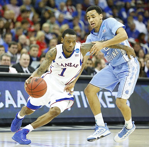 Kansas guard Naadir Tharpe is defended by North Carolina guard Marcus Paige during the second half, Sunday, March 24, 2013 at the Sprint Center in Kansas City, Mo.