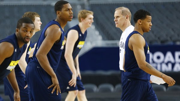 Michigan head coach John Beilein watches over the Wolverines as they stretch during a day of practices and press conference for teams in the South Regional at Cowboys Stadium in Arlington, Texas on Thursday, March 28, 2013.