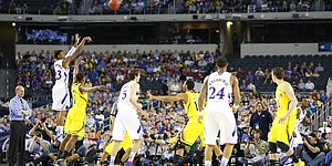 Kansas guard Ben McLemore puts up a three from the corner against Michigan during the first half on Friday, March 29, 2013 at Cowboys Stadium in Arlington, Texas.