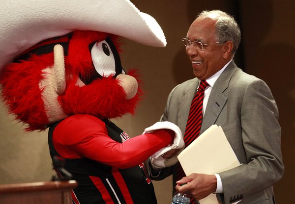 Texas Tech's mascot Raider Red welcomes Tubby Smith to the stage before Smith was introduced as the new men's basketball coach at Texas Tech during an NCAA college news conference in Lubbock, Texas, Tuesday, April 2, 2013.  (AP Photo/Lubbock Avalanche-Journal, Stephen Spillman)