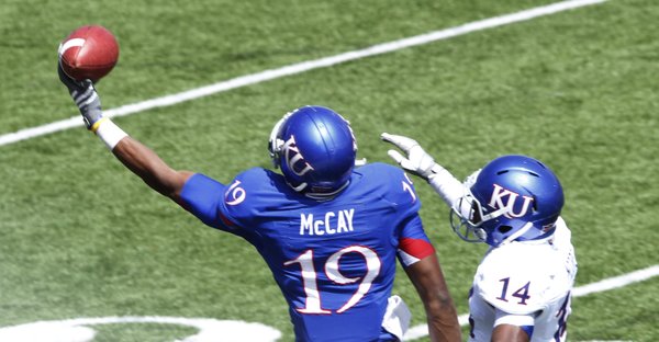 Kansas Blue team receiver Justin McCay makes a one-hand catch against the White team'ss Nasir Moore on Saturday, April 13, 2013, at the KU football spring game. The Blue team won, 34-7.
