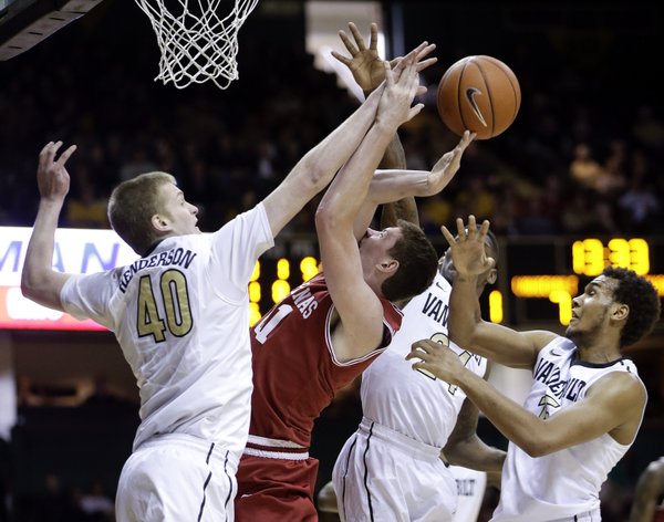 Arkansas forward Hunter Mickelson, second from left, loses the ball as he tries to shoot among Vanderbilt defenders Josh Henderson (40), Dai-Jon Parker (24) and Kevin Bright, right, during the first half on Saturday, Feb. 9, 2013, in Nashville, Tenn.