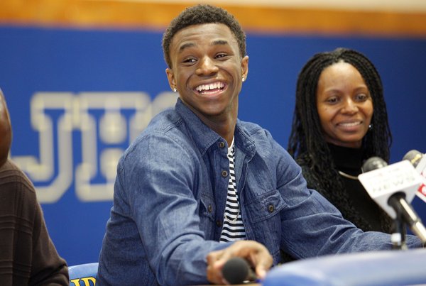 Huntington Prep basketball player Andrew Wiggins smiles along side his mother Marita Payne-Wiggins, right, as he announces his commitment to Kansas University during a ceremony on Tuesday, May 14, 2013, at St. Joseph High School in Huntington W.Va. The Canadian star, a top prospect, averaged 23.4 points and 11.2 rebounds per game this season for West Virginia's Huntington Prep.