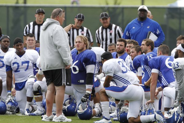 KU football coach Charlie Weis talks to the team during a break at practice Friday, August 16.