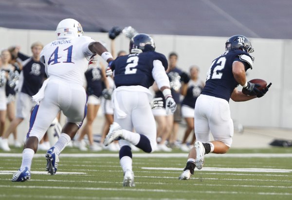 Rice linebacker Michael Kutzler picks off a tipped pass from Kansas quarterback Jake Heaps during the first quarter on Saturday, Sept. 14, 2013 at Rice Stadium in Houston, Texas. Kutzler ran back the interception for a touchdown.
