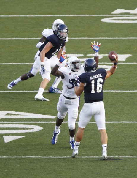 Kansas buck Michael Reynolds pressures Rice quarterback Taylor McHargue during the first quarter on Saturday, Sept. 14, 2013 at Rice Stadium in Houston, Texas.