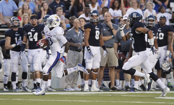 Kansas running back Tony Pierson leaves Rice cornerback Phillip Gaines in his wake as he races up the sideline for a touchdown during the second quarter on Saturday, Sept. 14, 2013 at Rice Stadium in Houston, Texas.