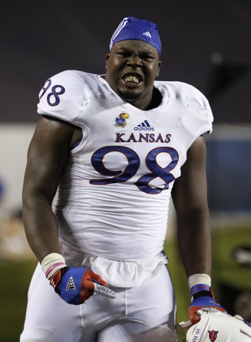Kansas defensive lineman Keon Stowers celebrates a Jayhawk interception by safety Isaiah Johnson against Rice during the third quarter on Saturday, Sept. 14, 2013 at Rice Stadium in Houston, Texas.