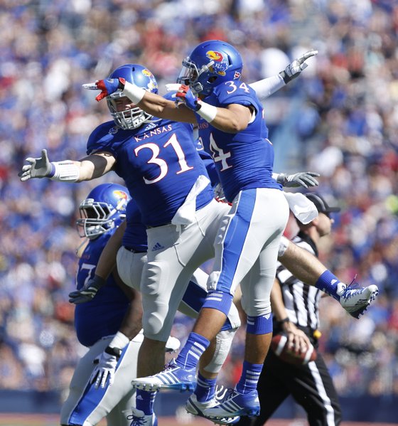 Kansas linebacker Ben Heeney (31) and running back Connor Embree (34) celebrate Heeney's interception against Louisiana Tech during the first quarter on Saturday, Sept. 21, 2013 at Memorial Stadium.