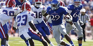 Kansas running back James Sims looks for yardage deep in Louisiana Tech territory during the second quarter on Saturday, Sept. 21, 2013 at Memorial Stadium.
