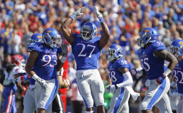 Kansas nickel back Victor Simmons (27) celebrates his sack of Louisiana Tech quarterback Ryan Higgins for a loss during the first quarter on Saturday, Sept. 21, 2013 at Memorial Stadium.