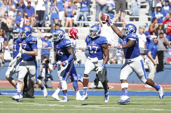 Kansas defensive lineman Keon Stowers comes away with the ball after recovering a Louisiana Tech fumble late in the fourth quarter to give the Jayhawks the ball back.