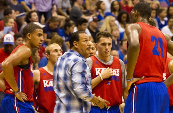 Coach Kurtis Townsend huddles with the red team during a timeout in the men's basketball scrimmage during Late Night in the Phog Friday at Allen Fieldhouse.