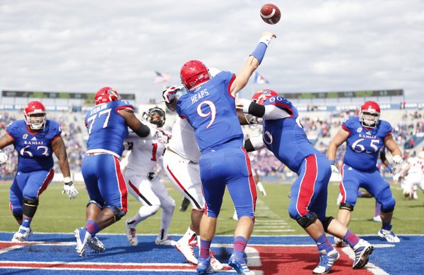 Kansas quarterback Jake Heaps throws out of the Jayhawks endzone against Texas Tech during the third quarter on Saturday, Oct. 5, 2013 at Memorial Stadium.
