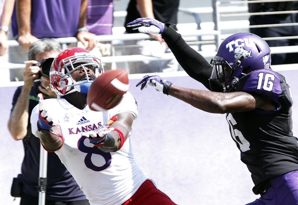Kansas receiver Josh Ford (8) looks to catch a pass but behind TCU's Keivon Gamble (16) on Saturday, Oct. 12, 2013. KU lost, 27-17.