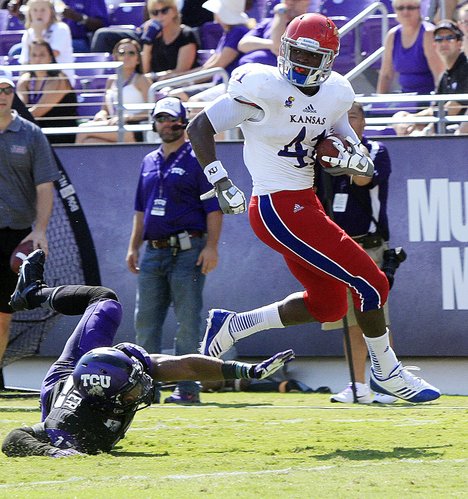Kansas tight end Jimmay Mundine (41) eludes TCU's Sam Carter (17) for a touchdown in the second half of TCU's 27-17 victory over KU on Oct. 12, 2013.