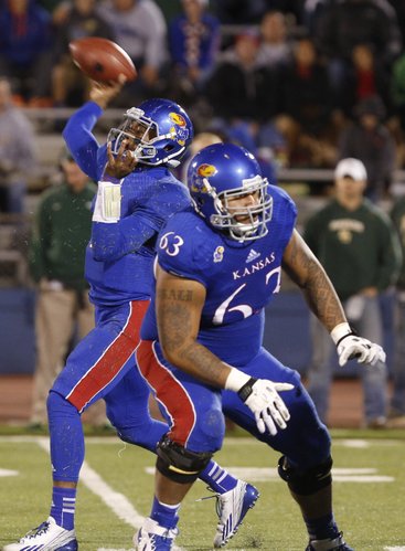 Kansas quarterback Montell Cozart throws as he gets protection from offensive lineman Ngalu Fusimalohi during the second quarter on Saturday, Oct. 26, 2013.