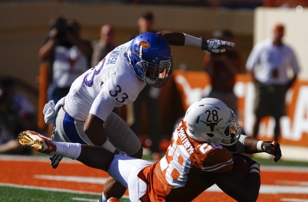 Texas running back Malcolm Brown falls just short of the endzone as Kansas safety Cassius Sendish comes in to cover during the second quarter on Saturday, Nov. 2, 2013 at Darrell K. Royal Stadium in Austin, Texas.