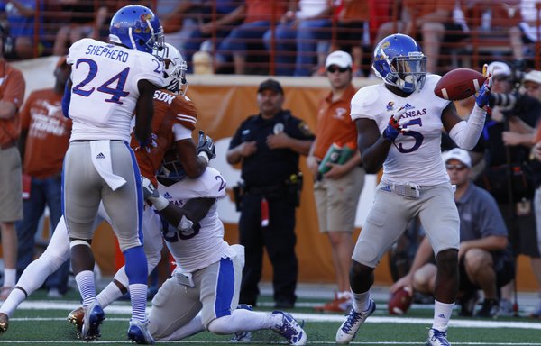 Kansas safety Isaiah Johnson comes away with his second interception of the game on a bobbled pass to a Texas receiver during the fourth quarter on Saturday, Nov. 2, 2013 at Darrell K. Royal Stadium in Austin, Texas.