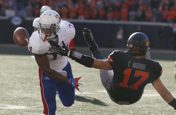Kansas cornerback JaCorey Shepherd knocks away a pass to Oklahoma State receiver Charlie Moore as Moore falls to the turf during the first quarter on Saturday, Nov. 9, 2013 at Boone Pickens Stadium in Stillwater, Oklahoma.