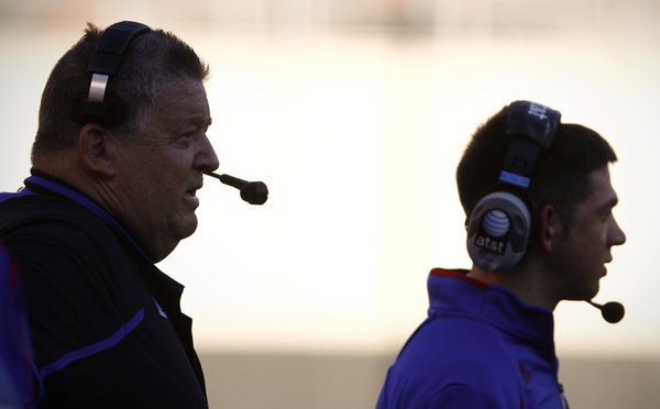 Kansas head coach Charlie Weis and his son, Charlie Weis Jr. watch from the sidelines during the second quarter on Saturday, Nov. 9, 2013 at Boone Pickens Stadium in Stillwater, Oklahoma.
