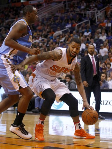Phoenix Suns power forward Marcus Morris (15), right, drives on Denver Nuggets power forward Darrell Arthur (00) in the third quarter during an NBA basketball game on Friday, Nov. 8, 2013, in Phoenix. The Suns defeated the Nuggets 114-93. (AP Photo/Rick Scuteri) 