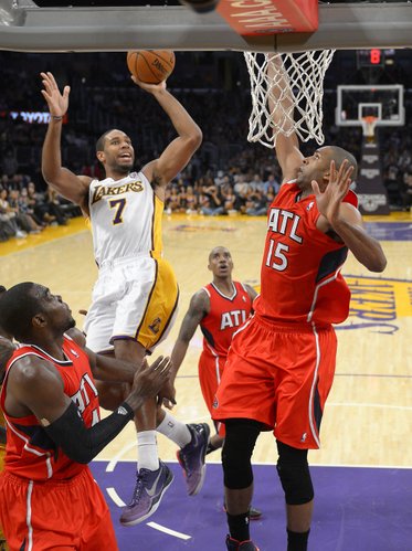 Los Angeles Lakers guard Xavier Henry, upper left, puts up a shot as Atlanta Hawks forward Paul Millsap, left, and Atlanta Hawks center Al Horford, of the Dominican Republic, defend during the second half of their NBA basketball game, Sunday, Nov. 3, 2013, in Los Angeles. The Lakers won 105-103. (AP Photo/Mark J. Terrill) 