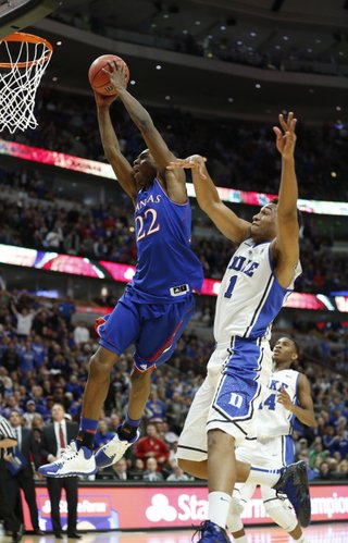 Kansas forward Andrew Wiggins soars in for a dunk past Duke forward Jabari Parker for a dunk late in the second half of the Champions Classic matchup on Tuesday, Nov. 12, 2013 at the United Center in Chicago.