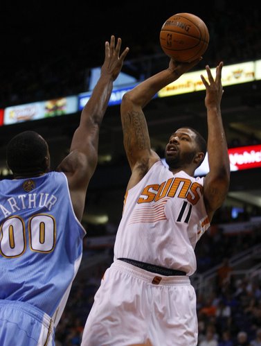 Phoenix Suns power forward Markieff Morris (11), right, scores over the top of Denver Nuggets power forward Darrell Arthur (00) in the third quarter during an NBA basketball game on Friday, Nov. 8, 2013, in Phoenix. The Suns defeated the Nuggets 114-93. (AP Photo/Rick Scuteri)