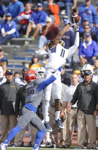 Kansas cornerback Dexter McDonald covers West Virginia receiver Kevin White as he narrowly misses a deep catch during the second quarter on Saturday, Nov. 16, 2013 at Memorial Stadium.