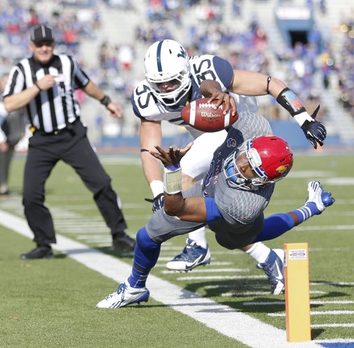Kansas quarterback Montell Cozart narrowly misses the pylon for a touchdown as he is pushed out-of-bounds by West Virginia linebacker Nick Kwiatkoski during the third quarter on Saturday, Nov. 16, 2013 at Memorial Stadium.