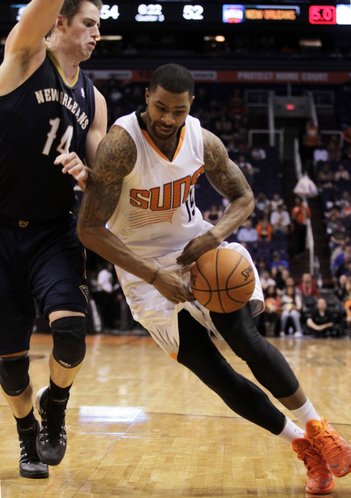 Phoenix Suns forward Marcus Morris (15), right, drives on New Orleans Pelicans center Jason Smith (14) in the third quarter during an NBA basketball game on Sunday, Nov. 10, 2013, in Phoenix. The Suns defeated the Pelicans 101-94. (AP Photo/Rick Scuteri)
