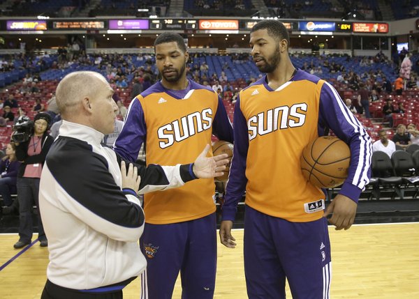 Official Ron Garretson talks with Phoenix Suns forwards Marcus Morris center and his twin brother Markieff, before an NBA preseason basketball game against the Sacramento KIngs in Sacramento, Calif., Thursday, Oct. 17, 2013. (AP Photo/Rich Pedroncelli)

