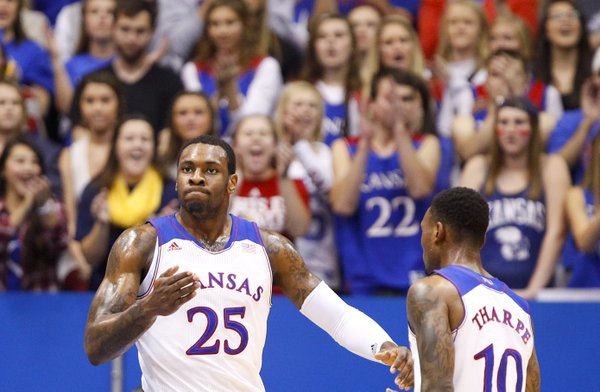 Kansas forward Tarik Black pounds his chest next to teammate Naadir Tharpe after a dunk against Towson during the first half on Friday, Nov. 22, 2013 at Allen Fieldhouse.