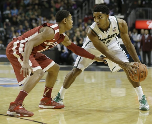 Oklahoma's Isaiah Cousins (11) guards Michigan State's Gary Harris (14) during the first half of the championship game in the Coaches vs. Cancer NCAA college basketball game on Saturday, Nov. 23, 2013, in New York. (AP Photo/Frank Franklin II)