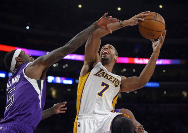 Los Angeles Lakers forward Xavier Henry, right, puts up a shot as Sacramento Kings forward John Salmons defends during the first half of an NBA basketball game Sunday, Nov. 24, 2013, in Los Angeles. (AP Photo/Mark J. Terrill) 
